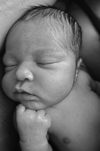 a black and white photo of a baby sleeping